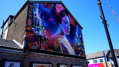 A professional mural and street artist has been painting Japanese inspired art in parts of Belfast.
