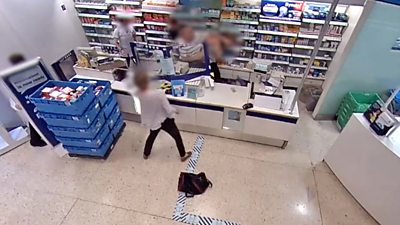 A still from CCTV footage showing a customer assaulting a Boots shop worker