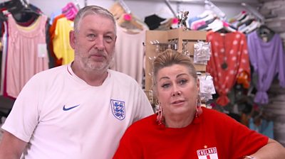 Two people wearing England shirts