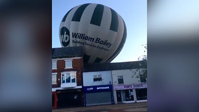 A still from the video shows the hot air balloon coming down in the town centre.