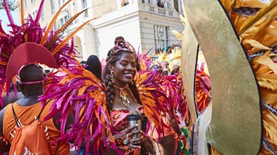 A dancer in a feathery outfit at Notting Hill Carnival 2019