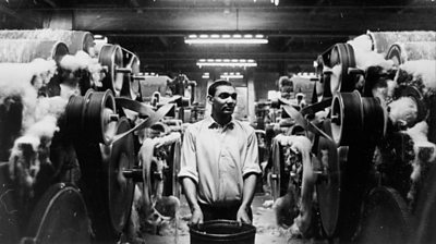 circa 1950: An immigrant employee from Pakistan at work in a spinning mill in Bradford, West Yorkshire, the worsted-manufacturing and wool-trade centre of England. 