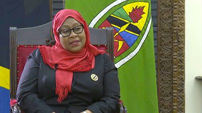 Tanzanian president Samia Sulu Hassan in front of a flag