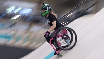 Lily on wheelchair whizzing down ramp