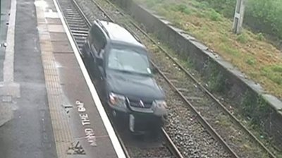 CCTV captures man driving down railway