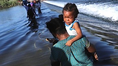 A child is carried over the Rio Grande on the US-Mexico border, 17 September 2021