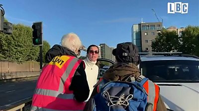 Woman confronts protesters