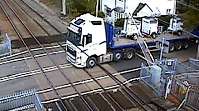 Lorry reverses into level crossing