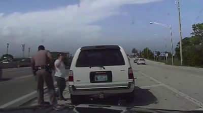 Police dashcam shows close call during highway crash - BBC News