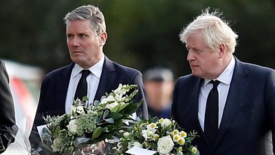 Sir Keir Starmer and Boris Johnson hold flowers in Leigh-on-Sea, 16 October 2021