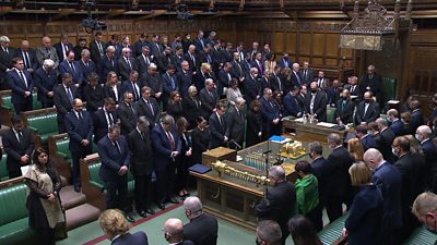 MPs with bowed heads in House of Commons