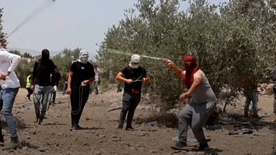Protester wearing a mask throwing rocks