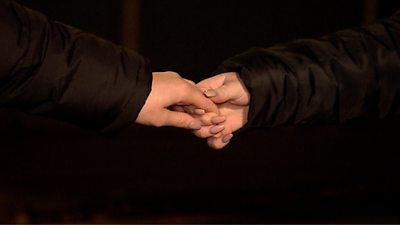 Two people holding hands