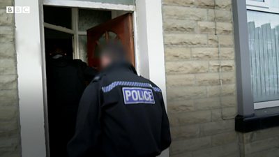 Police enter door of suspected brothel