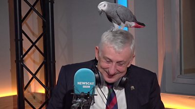 Sir Lindsay Hoyle with a parrot on his head.