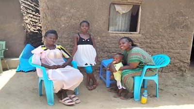 Mama Lia, far left, is shown with her family at her home in Joppa, South Sudan. Credit: BBC Media Action
