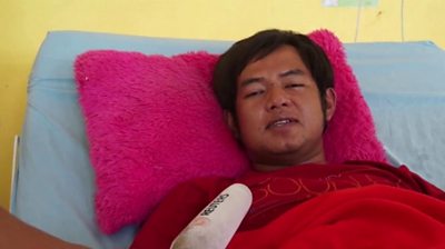 A survivor of the Mt Semeru eruption speaks in bed