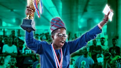 Adeoye Fawaz holding a chess trophy