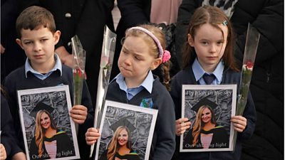 Children hold tributes to their teacher Ashling Murphy