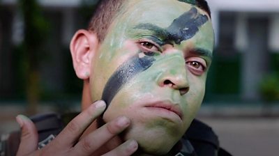 Soldier applying face paint