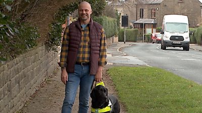 A man with a guide dog