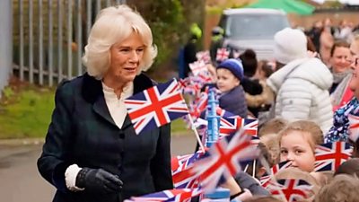 The Duchess of Cornwall with children waving flags