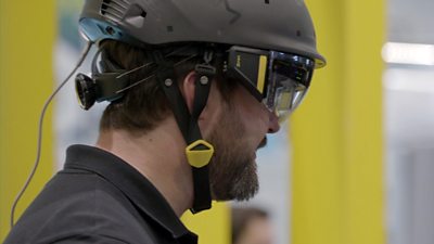 David Mitchell, founder and CEO of XYZ Reality wears a helmet with augmented reality glasses