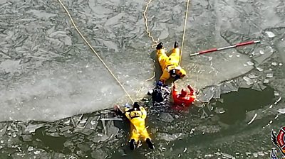 Two US teens fell through lake ice - luckily for them firefighters were training nearby for just such a rescue.