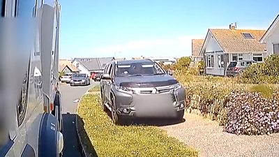 Car on pavement squeezing past bin lorry