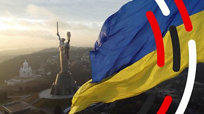 Ukraine flag in front of statue