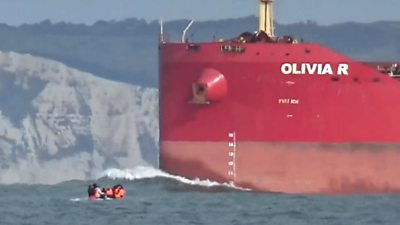 Migrant dinghy dwarfed by tanker in English Channel