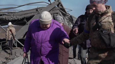 woman holding soldiers hand in Irpin, Ukraine