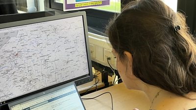 Worker looking at map of Ukraine