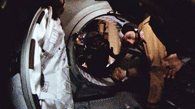 Astronaut Thomas Stafford and cosmonaut Aleksei Leonov make their historic handshake in space