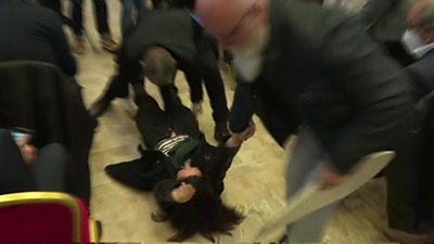 Protester dragged from news conference