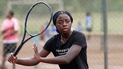 Girl holding a tennis racket.