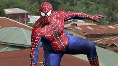 man in a spiderman costume posing on a rooftop