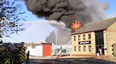 Firefighters tackling flames at a factory building