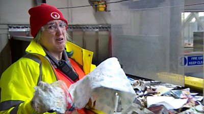 Catherine Crosthwaite removes non-recyclable items from a conveyor belt