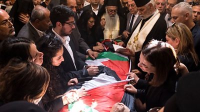 Mourners surround the coffin of killed journalist Shireen Abu Aqla