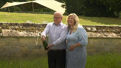 Joe and Jess Thwaite celebrate their lottery win with champagne