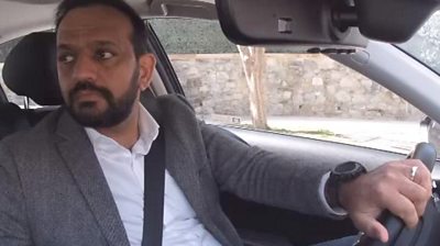 Former finance minister of Afghanistan Khalid Payenda drives a ride-share cab