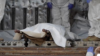 A bag containing a body on a stretcher