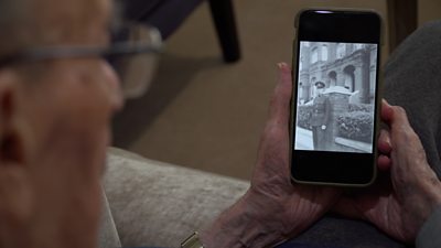 92-year-old George Vulkan looking at his younger self in the British army