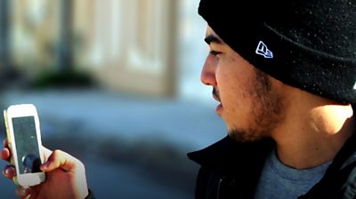 North African man looking at mobile phone