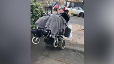 Man in power chair nearly tipping over