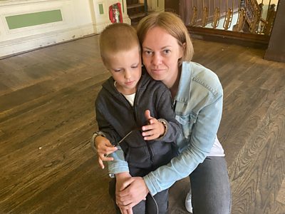 woman hugging young boy