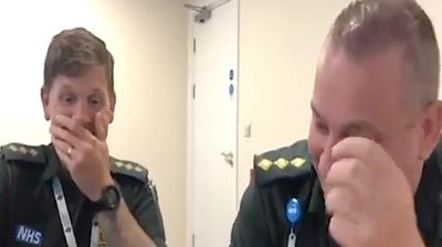The pair struggle to keep straight faces while filming to mark International Paramedics Day.