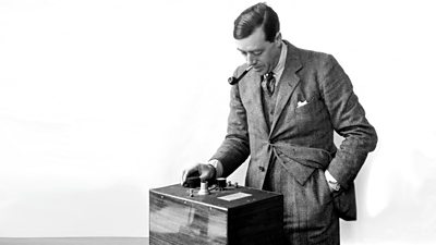 Peter Eckersley with pipe and tweed suit examines a piece of apparatus