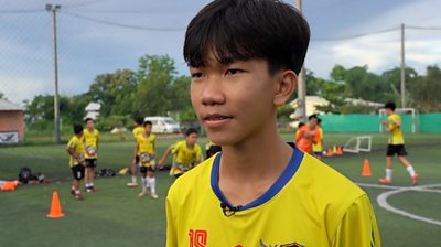 Rescued Thai boy known as "Titan" at a football field